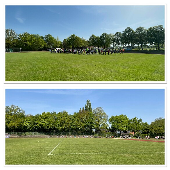 auf dem Foto sieht man den grünen Rasen der Bezirkssportanlage Hemelingen. Im Hintergrund laufen Kinder über die Tartanbahn